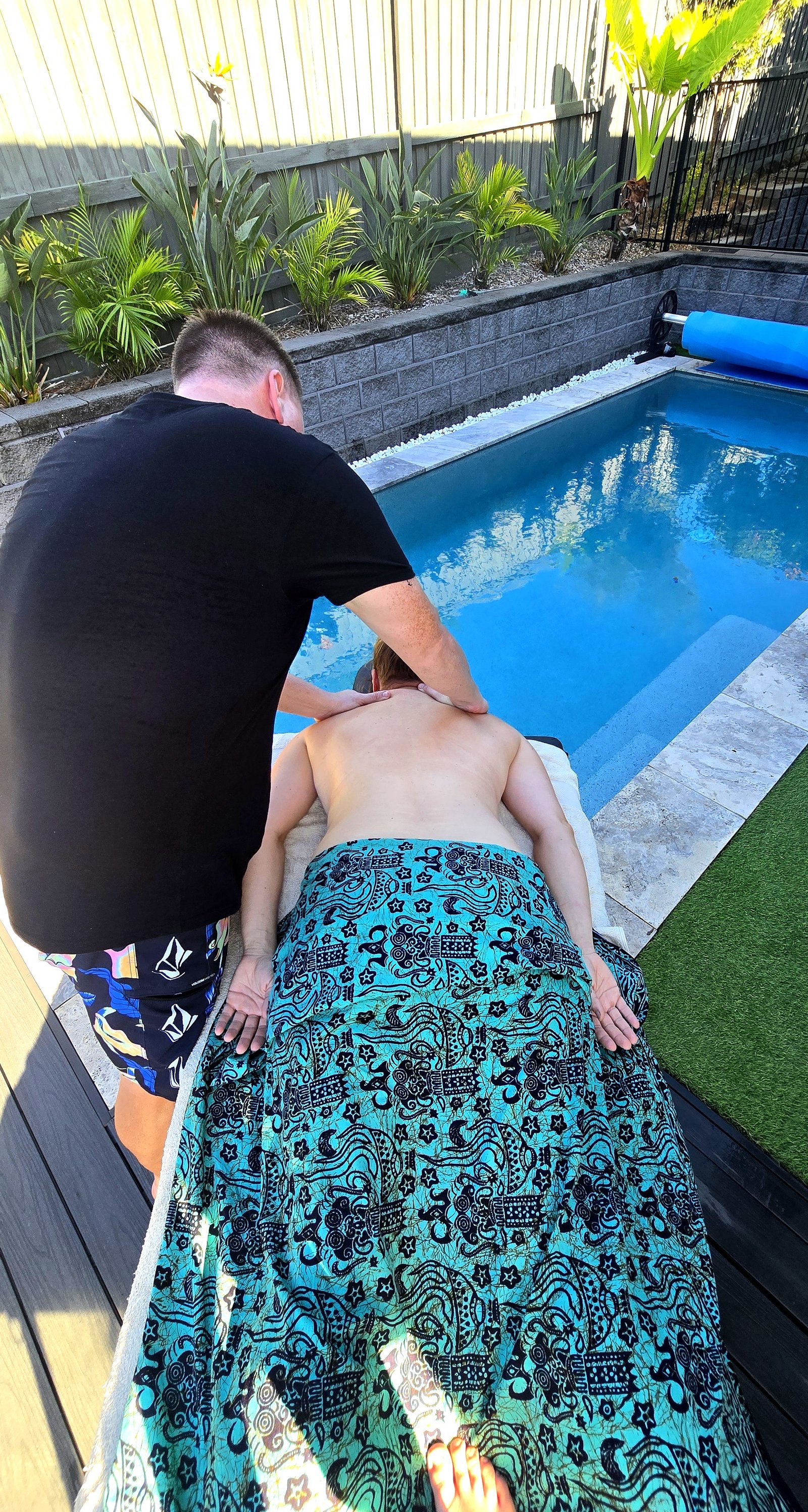 Outdoor poolside massage session